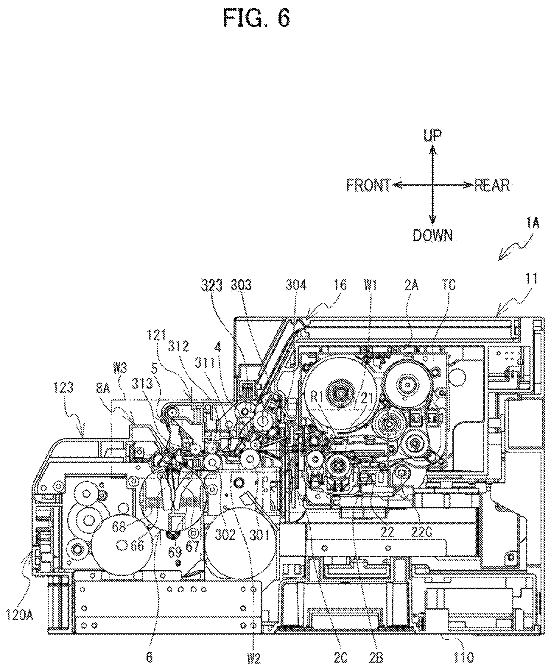Patent US12617575 Figure 6 – Label affixing device including peeling part peeling label off release material, affixing part affixing label to adherend, and discharge part through which release material is discharged